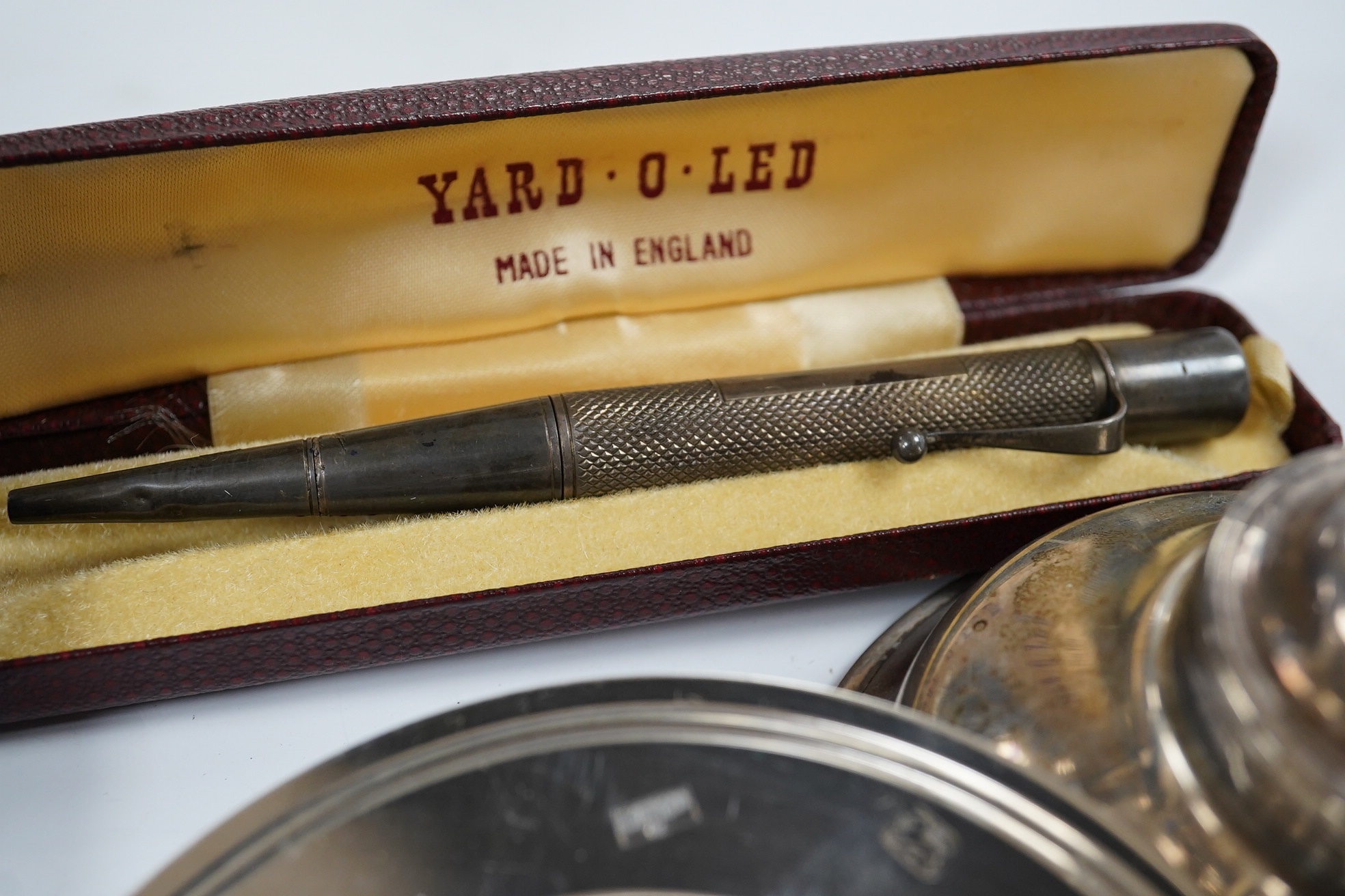 Sundry small silver including a modern wine funnel, silver dishes including cased, cigarette cases, sovereign case, wine label etc. Condition - poor to fair